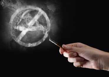 No Smoking sign of smoke near woman with cigarette on black background, closeup