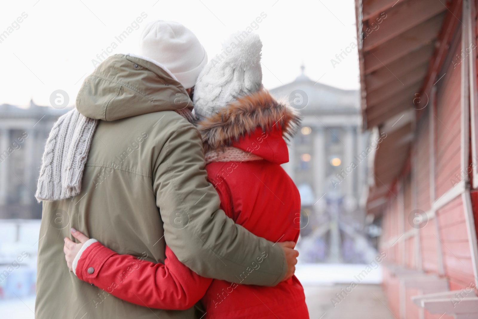 Photo of Happy young couple spending time together at winter fair. Christmas celebration