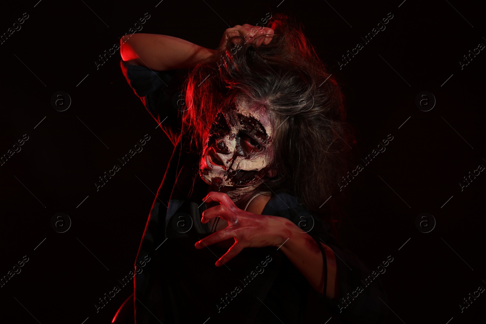 Photo of Scary zombie on dark background. Halloween monster