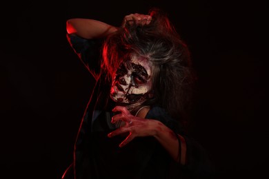 Scary zombie on dark background. Halloween monster