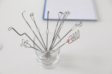 Photo of Set of different logopedic probes in holder on light table. Speech therapist's tools