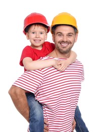 Father and son in hard hats having fun on white background