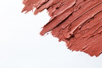 Photo of Strokes of lipstick on white background, top view