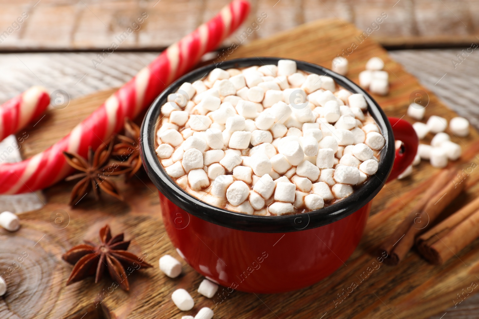 Photo of Tasty hot chocolate with marshmallows on wooden table, closeup