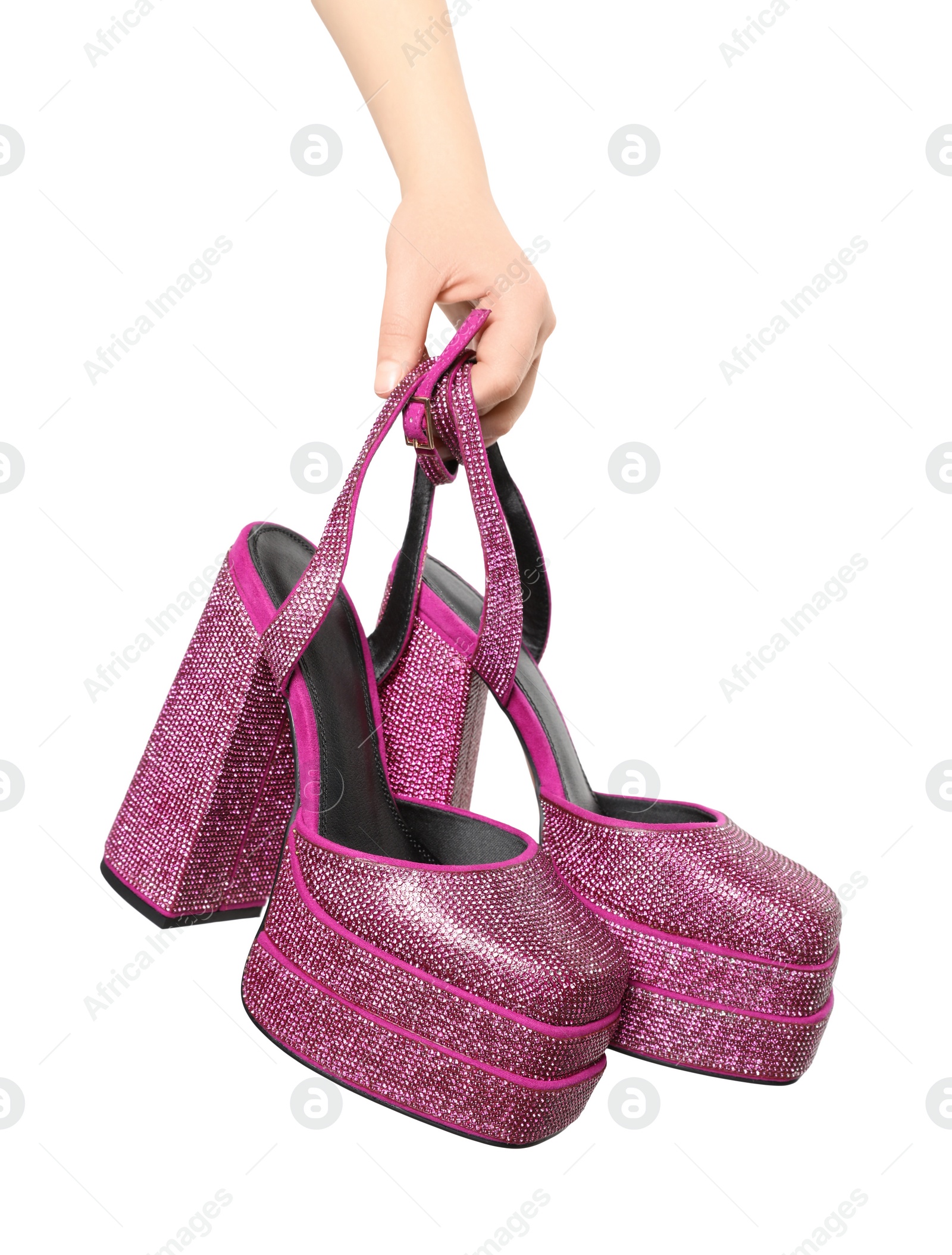 Photo of Woman holding fashionable punk square toe ankle strap pumps on white background, closeup. Shiny party platform high heeled shoes