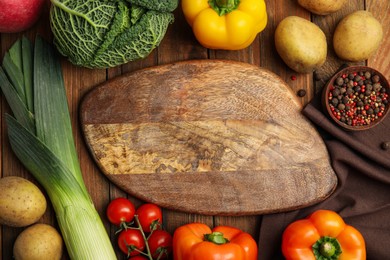 Empty board and different fresh products on wooden table, flat lay with space for text. Cooking Classes