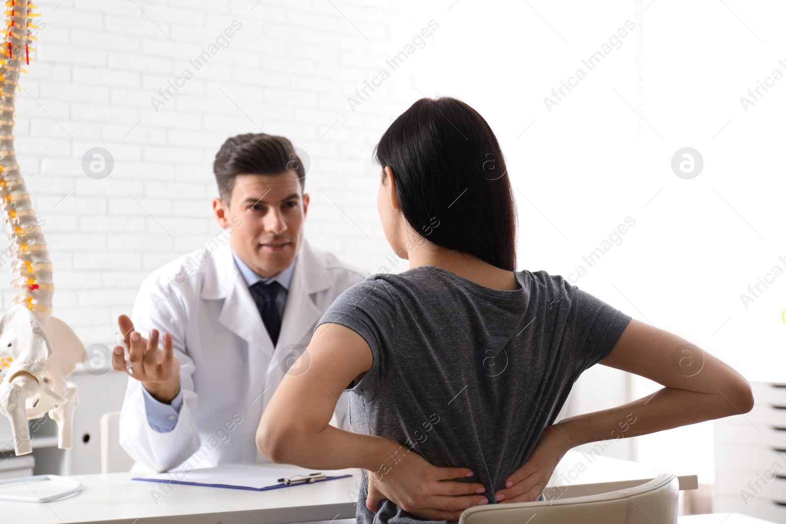 Photo of Young woman visiting orthopedist in medical office