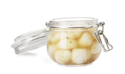 Photo of Glass jar with preserved garlic on white background