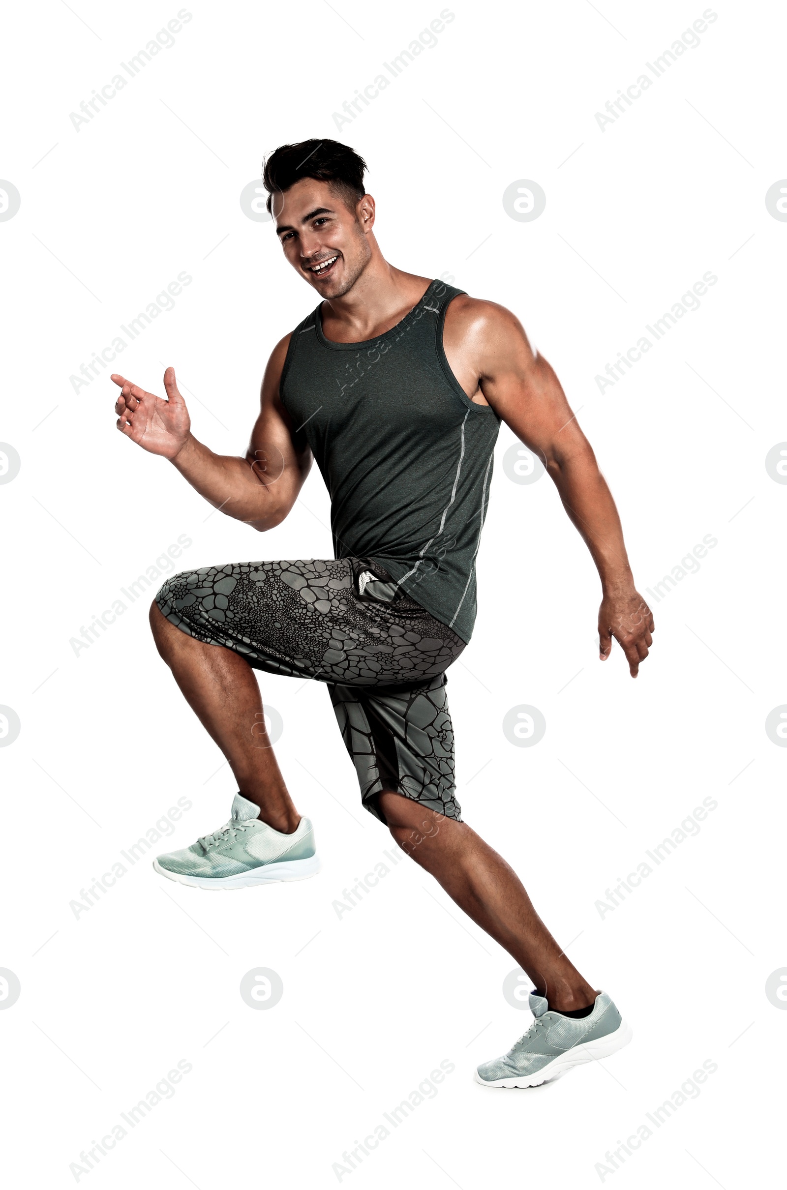 Photo of Handsome young man running on white background