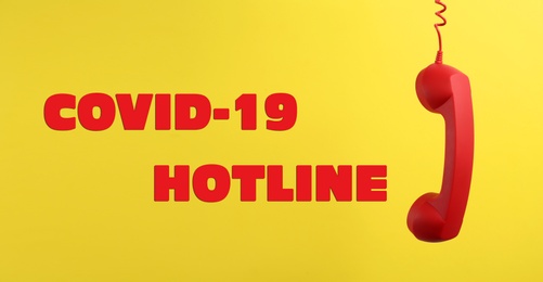 Image of Covid-19 Hotline. Red handset and text on yellow background, banner design 