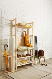 Cozy hallway interior with wooden shelving unit. Stylish design idea