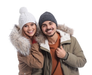 Young couple wearing warm clothes on white background. Ready for winter vacation