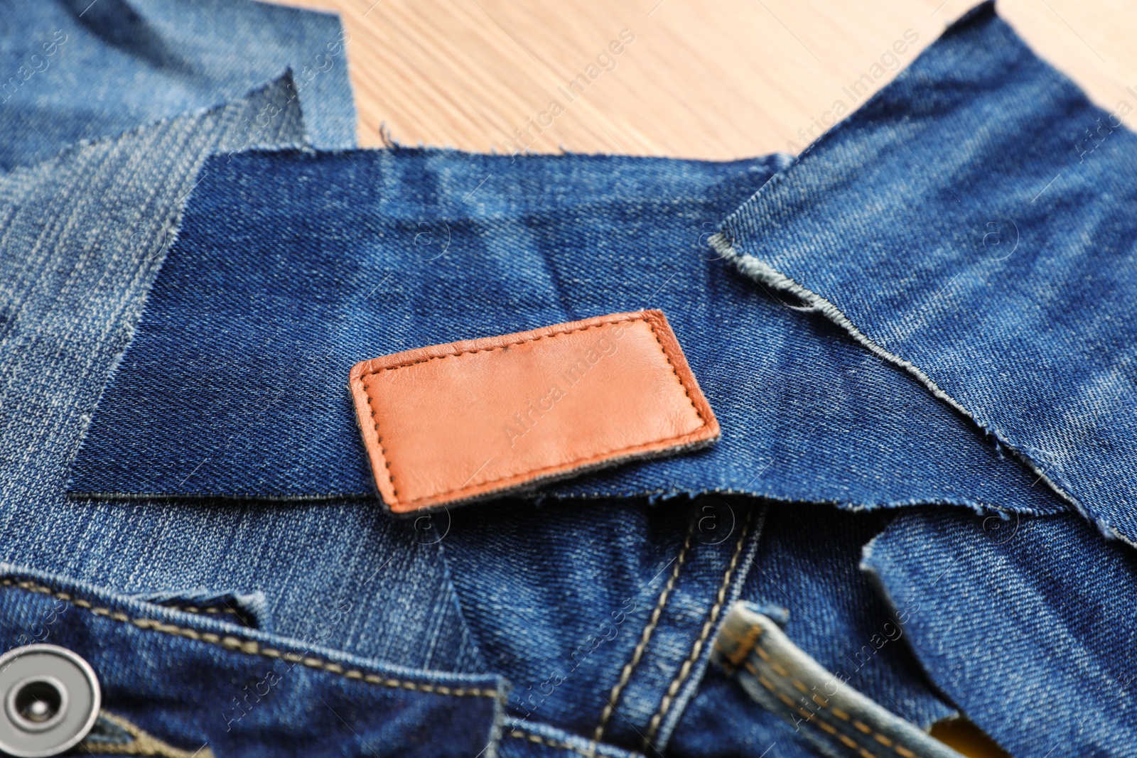 Photo of Many patches of old jeans on table, closeup