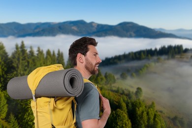 Happy tourist with yellow backpack in mountains