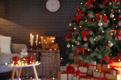 Photo of Blurred view of stylish room interior with decorated Christmas tree