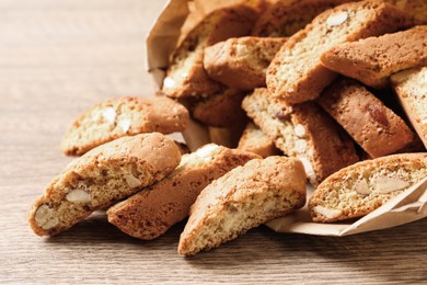 Photo of Traditional Italian almond biscuits (Cantucci) on wooden table, closeup
