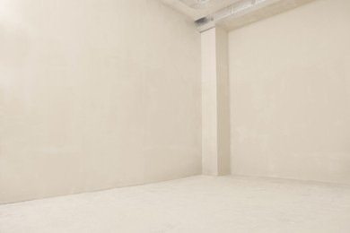 Photo of Empty beautiful clean room with beige walls after renovation