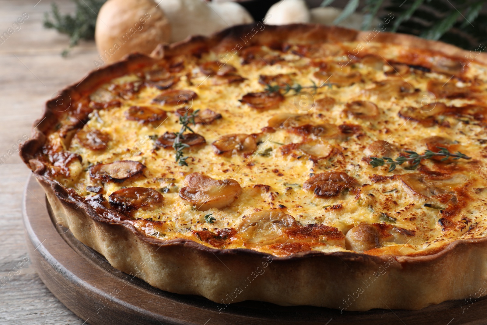 Photo of Delicious homemade mushroom pie on wooden table, closeup