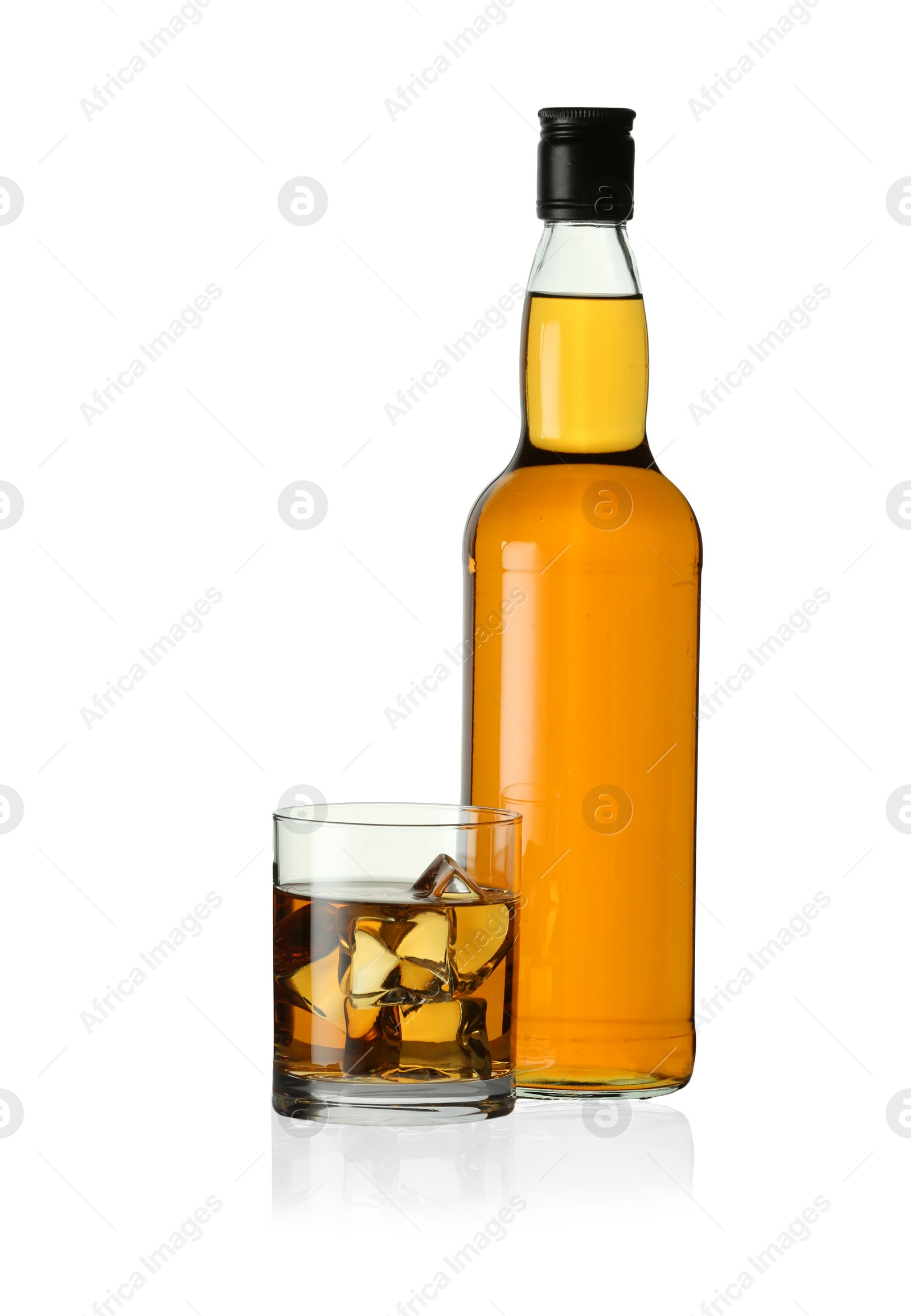 Photo of Whiskey in glass and bottle isolated on white