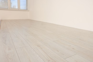 Photo of Empty room with new white laminated flooring