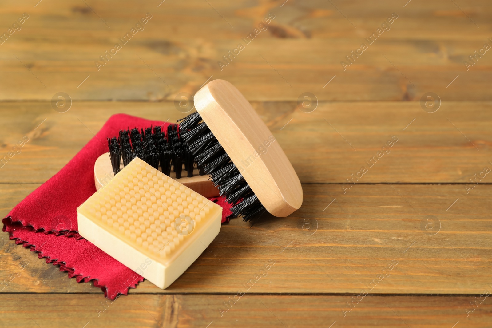 Photo of Composition with shoe care accessories on wooden background, space for text