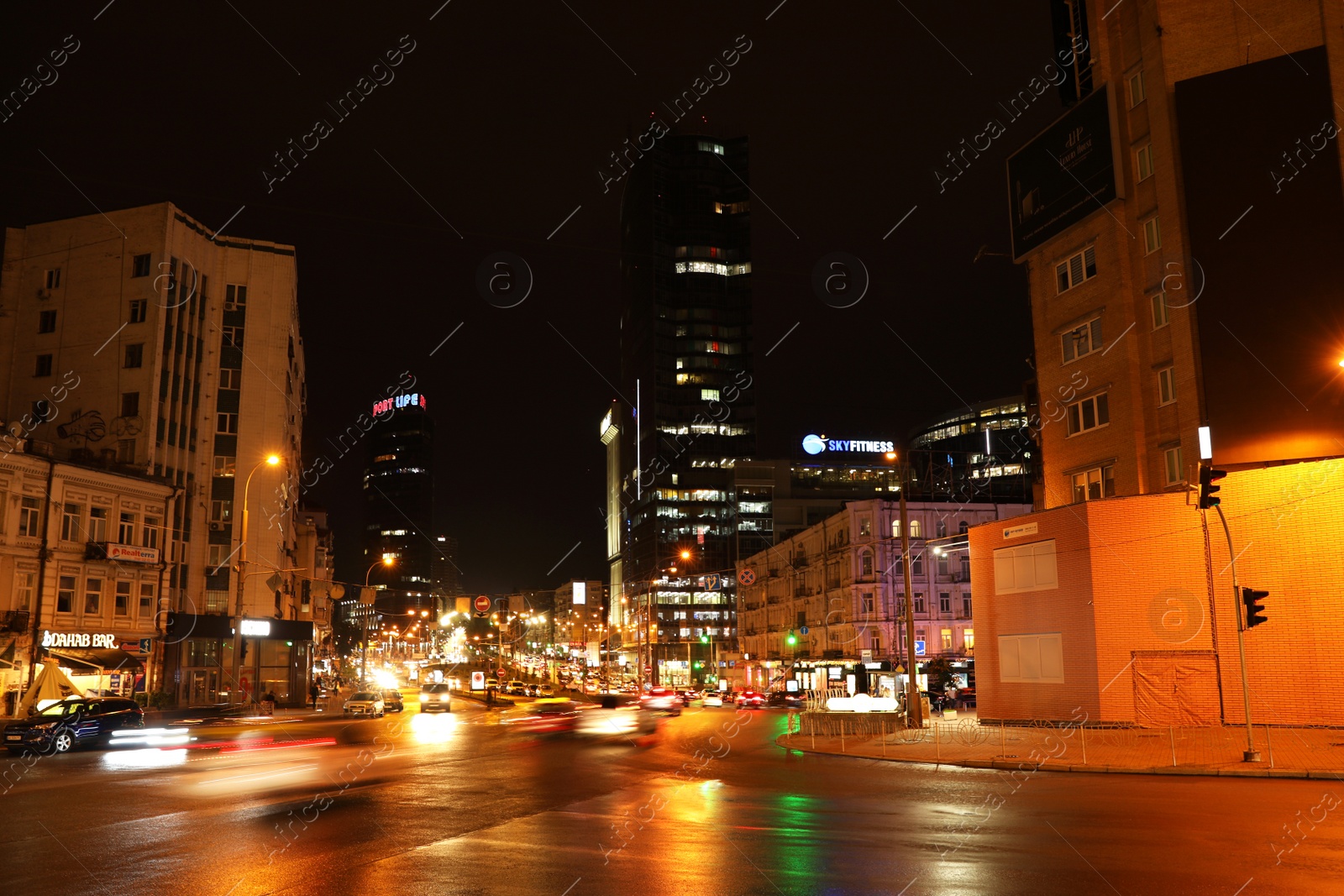 Photo of KYIV, UKRAINE - MAY 22, 2019: View of night city with illuminated buildings and road traffic