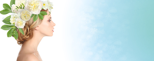 Young woman with beautiful makeup wearing flower wreath on blue background, space for text. Banner design