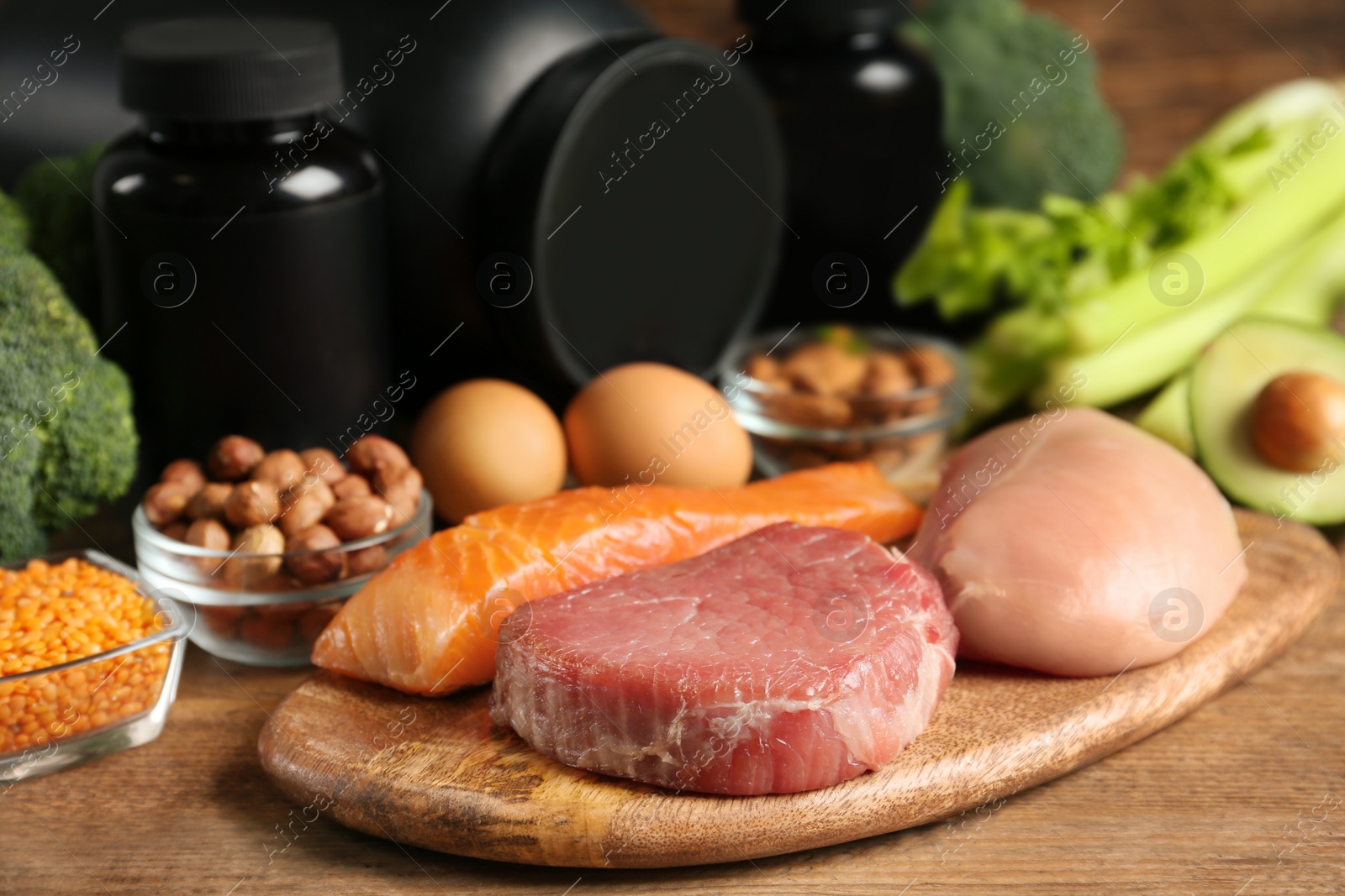 Photo of Set of products rich in amino acids and supplements on wooden table