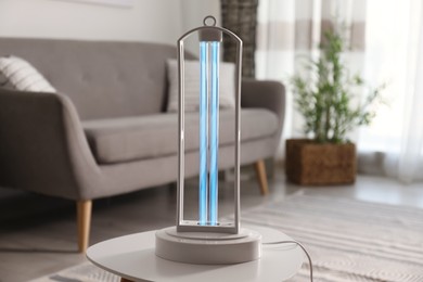 Photo of UV lamp for light sterilization on table in living room