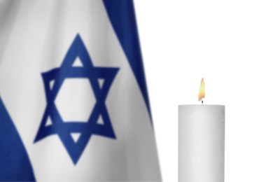 Image of Burning candle and flag of Israel on white background