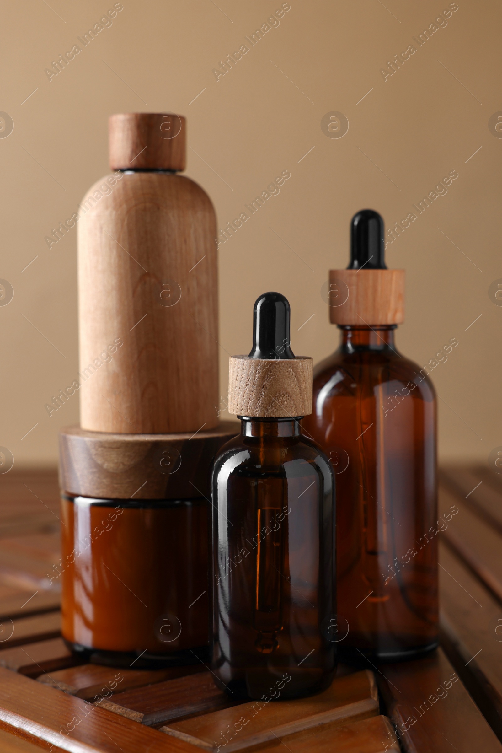 Photo of Set of different luxury cosmetic products on wooden table