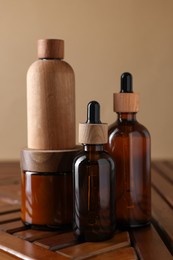 Photo of Set of different luxury cosmetic products on wooden table