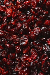 Photo of Tasty cranberries as background, top view. Dried fruits as healthy snack