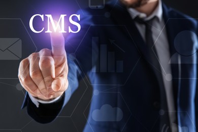 Image of CMS. Man using virtual screen on dark background, closeup