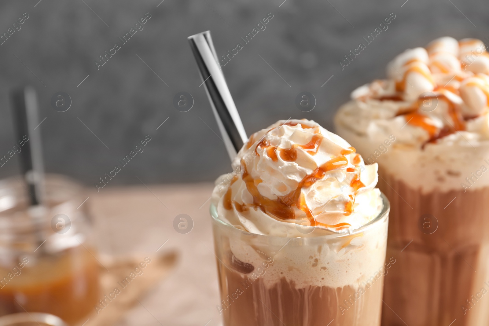 Photo of Glass with delicious caramel frappe, closeup