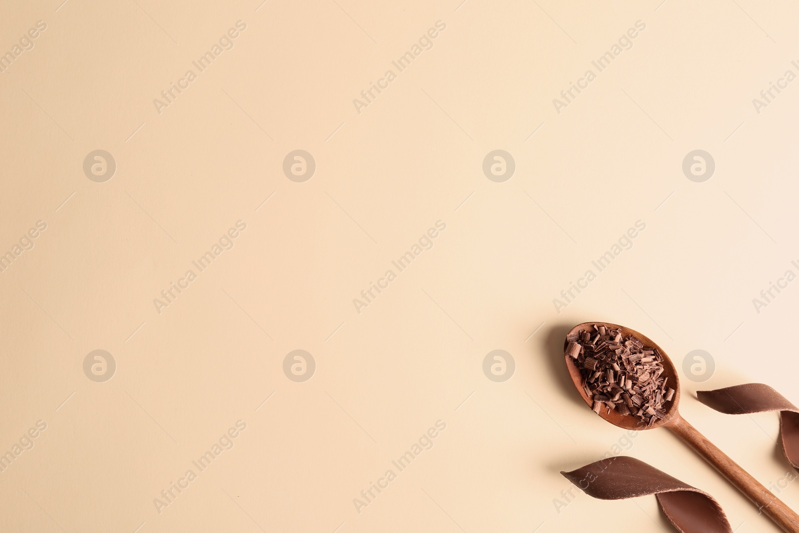 Photo of Flat lay composition with chocolate curls and space for text on color background