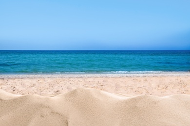 Image of Beautiful sandy beach near sea under blue sky