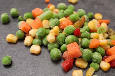 Photo of Mix of different frozen vegetables on grey table, closeup