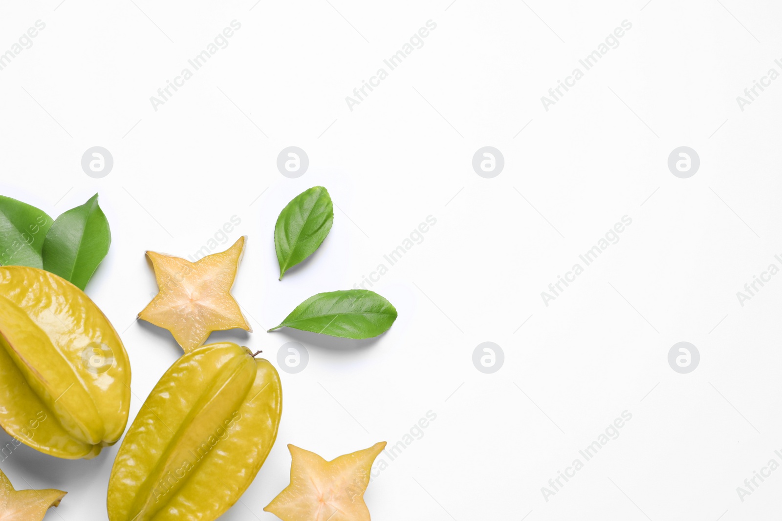 Photo of Flat lay composition with carambolas on white background. Space for text