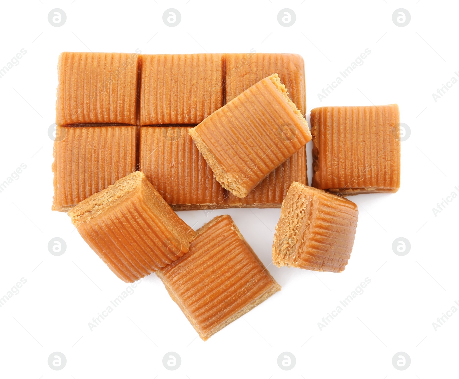 Photo of Delicious caramel candies on white background