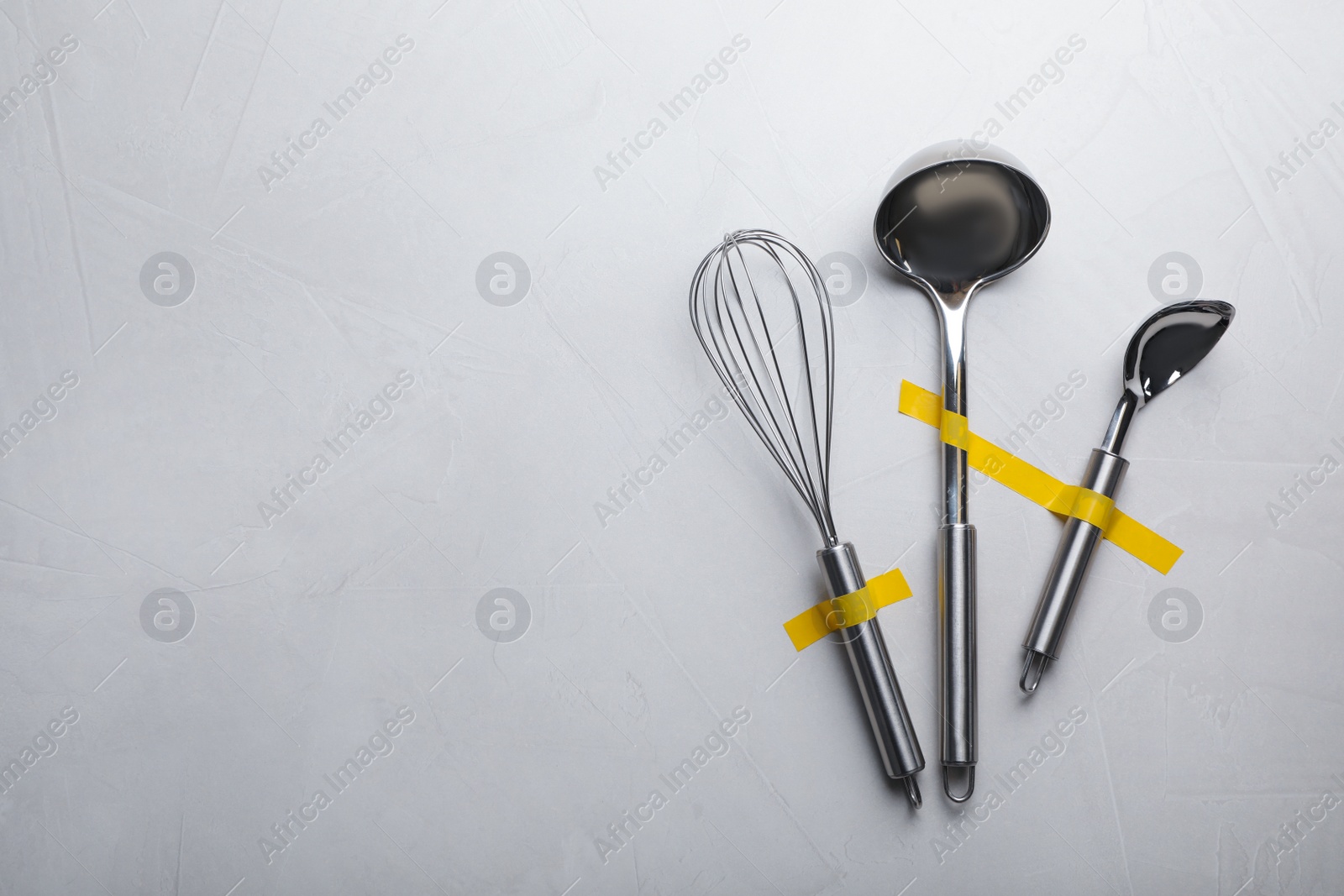 Photo of Clean kitchen utensils on grey background, flat lay. Space for text