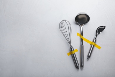 Clean kitchen utensils on grey background, flat lay. Space for text