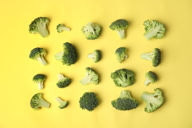 Photo of Flat lay composition with fresh green broccoli on color background