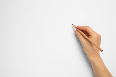 Photo of Woman with new graphite pencil on white background, top view. Space for text