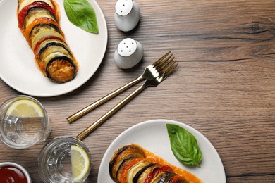 Photo of Delicious ratatouille served on wooden table, flat lay