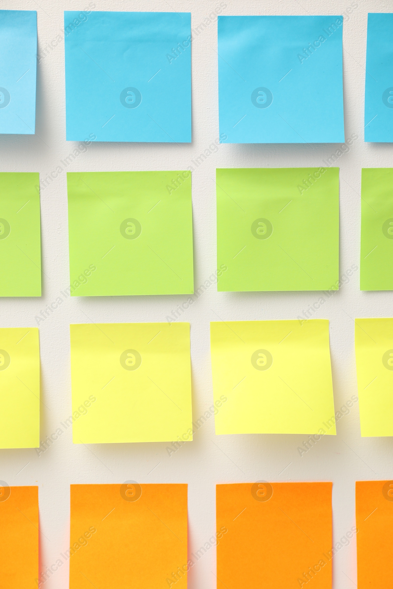 Photo of Blank colorful paper notes on white board, closeup