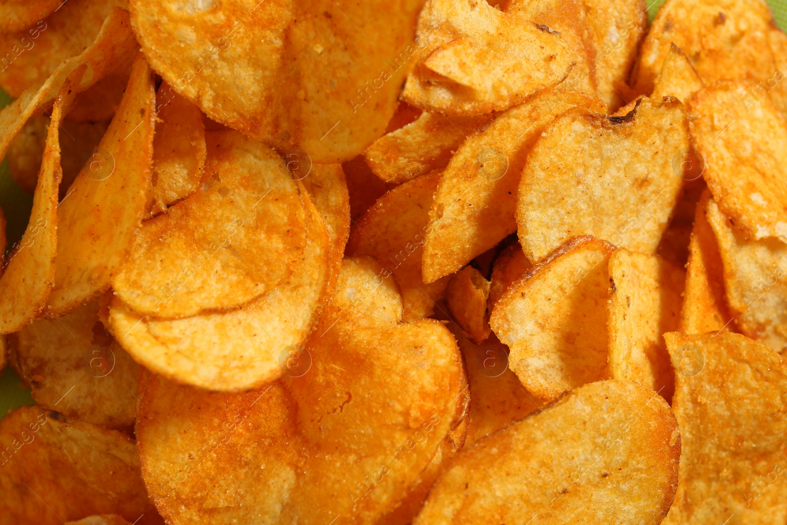 Photo of Crispy potato chips as background, closeup view