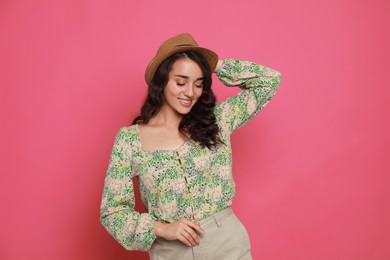 Photo of Beautiful young woman with straw hat on pink background