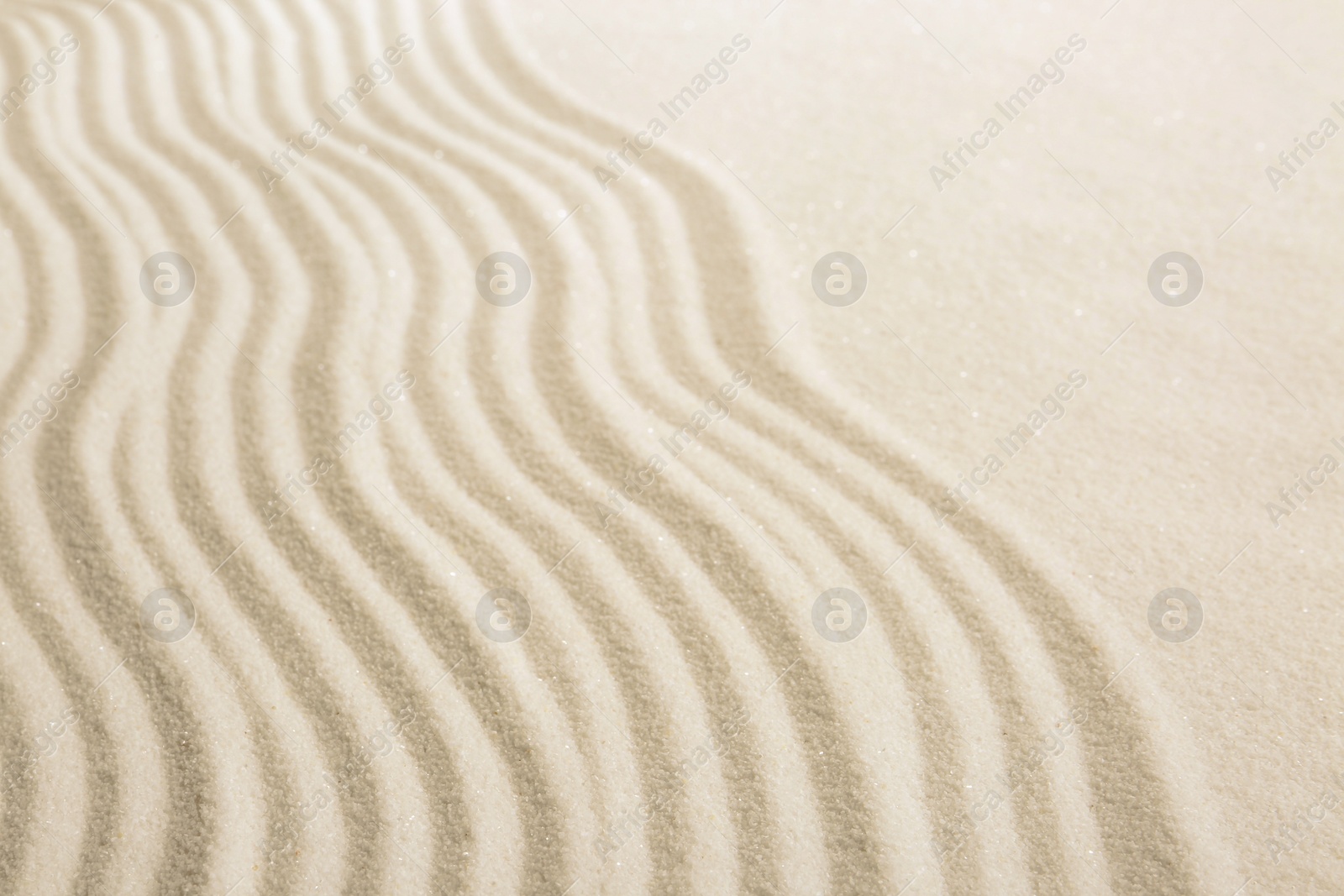 Photo of Zen rock garden. Wave pattern on white sand, closeup