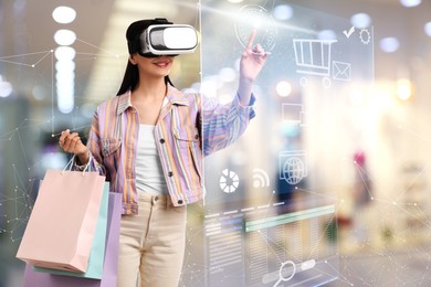 Image of Young woman with shopping bags using virtual reality headset in simulated store